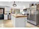 Modern kitchen with white cabinets, butcher block island, and stainless steel appliances at 8262 Fairview Nursery Rd, Hollywood, SC 29449