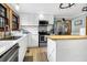 Charming kitchen features white cabinetry, a wood top island, and stainless appliances at 8262 Fairview Nursery Rd, Hollywood, SC 29449