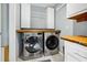 Modern laundry room with front load washer and dryer, with storage cabinets at 8262 Fairview Nursery Rd, Hollywood, SC 29449