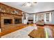 Cozy living room showcasing a brick fireplace and views of the outdoor scenery at 8262 Fairview Nursery Rd, Hollywood, SC 29449