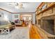 Open-concept living room with brick fireplace and access to the dining area at 8262 Fairview Nursery Rd, Hollywood, SC 29449