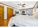 Main bedroom with wood floors, ceiling fan, light blue walls, and closet at 8262 Fairview Nursery Rd, Hollywood, SC 29449