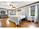 Spacious main bedroom with wood floors, ceiling fan, lots of natural light and windows at 8262 Fairview Nursery Rd, Hollywood, SC 29449