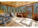 Screened in porch with natural light, wood flooring, and wood framing at 8262 Fairview Nursery Rd, Hollywood, SC 29449