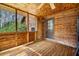 Enclosed porch features wood walls, flooring, ceiling fan and door to the exterior at 8262 Fairview Nursery Rd, Hollywood, SC 29449
