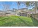 Wide angle of large backyard with manicured lawn and a screened-in porch at 8475 Athens Way, North Charleston, SC 29420