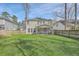 Expansive backyard featuring a well-maintained lawn and screened-in porch at 8475 Athens Way, North Charleston, SC 29420
