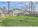 Large backyard featuring a well-manicured lawn and a screened-in porch at 8475 Athens Way, North Charleston, SC 29420