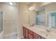 Bright bathroom featuring a double vanity, framed mirror, and shower at 8475 Athens Way, North Charleston, SC 29420