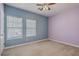 Spacious bedroom with two windows letting in plenty of natural light and a ceiling fan at 8475 Athens Way, North Charleston, SC 29420