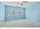 Well-lit bedroom with three windows and neutral carpet at 8475 Athens Way, North Charleston, SC 29420