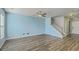 Spacious living room with hardwood floors, a ceiling fan, and a staircase to the second floor at 8475 Athens Way, North Charleston, SC 29420