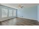 Bright main bedroom features large windows, neutral paint, hardwood floors, and ample space at 8475 Athens Way, North Charleston, SC 29420