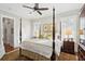 A comfortable main bedroom features a four poster bed, neutral walls and a dark wood floor at 894 Tupelo Bay Dr, Mount Pleasant, SC 29464