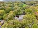 Aerial view showcases a beautiful home with a lush, mature canopy of trees and a serene landscape at 93 Surfscoter Ln, Kiawah Island, SC 29455