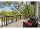 Charming balcony with wicker chairs and scenic views, perfect for relaxing and enjoying the outdoors at 93 Surfscoter Ln, Kiawah Island, SC 29455