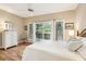 Cozy bedroom featuring hardwood floors, a ceiling fan, and sliding glass doors to balcony at 93 Surfscoter Ln, Kiawah Island, SC 29455