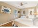 Bedroom with hardwood floors, ceiling fan, and an ensuite bathroom at 93 Surfscoter Ln, Kiawah Island, SC 29455