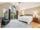 Bright bedroom with hardwood floors, ceiling fan, and sliding glass doors to balcony at 93 Surfscoter Ln, Kiawah Island, SC 29455