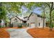 Charming home with lush landscaping, mature trees, and a spacious driveway offering a welcoming curb appeal at 93 Surfscoter Ln, Kiawah Island, SC 29455