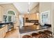 Modern kitchen with an island, stainless steel appliances, light wood cabinets, and hardwood floors at 93 Surfscoter Ln, Kiawah Island, SC 29455