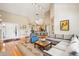 Open concept living area flowing into the kitchen with hardwood floors and plenty of natural light at 93 Surfscoter Ln, Kiawah Island, SC 29455