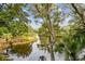 Scenic water view framed by lush trees and foliage, offering a tranquil and inviting ambiance at 93 Surfscoter Ln, Kiawah Island, SC 29455