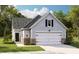 Charming single-Gathering home with a two-car garage, stone accents, and a well-manicured lawn at 1029 Sagegrass St, Summerville, SC 29485