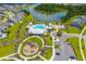 Aerial view of a community pool, playground, and parking area nestled amidst lush landscaping and scenic waterways at 108 Whaler Ave, Summerville, SC 29486