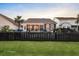 Landscaped backyard showing fence, lawn, tropical plants, and neighboring houses at 108 Whaler Ave, Summerville, SC 29486