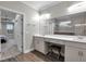 Bathroom featuring double sink vanity, stool, and doorway to ensuite at 108 Whaler Ave, Summerville, SC 29486
