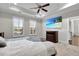 Bright bedroom features tray ceiling, ceiling fan, plush carpet, and beach scene on TV at 108 Whaler Ave, Summerville, SC 29486