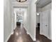Inviting hallway featuring hardwood floors and decorative lighting leading into an open-concept layout at 108 Whaler Ave, Summerville, SC 29486