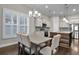 Open kitchen and dining area featuring stainless steel appliances, white cabinets, and wooden island at 108 Whaler Ave, Summerville, SC 29486