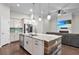 Kitchen featuring a large island, stainless steel appliances, and an adjacent living room area at 108 Whaler Ave, Summerville, SC 29486