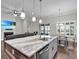Open kitchen with stainless steel appliances, wooden accents, an island with granite counters and pendant lights at 108 Whaler Ave, Summerville, SC 29486