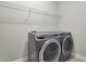 Modern laundry room features front load washer and dryer set with wire shelving at 108 Whaler Ave, Summerville, SC 29486
