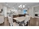 Open-concept living room with the view of the kitchen and dining area; hardwood flooring throughout the house at 108 Whaler Ave, Summerville, SC 29486
