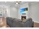 Cozy living room featuring a fireplace with a large TV screen and comfortable gray sofa at 108 Whaler Ave, Summerville, SC 29486