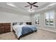 Bedroom with a tray ceiling, ceiling fan, large windows, and carpet at 108 Whaler Ave, Summerville, SC 29486