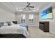 Bedroom boasts a tray ceiling, ceiling fan, large windows, carpet, and a TV screen at 108 Whaler Ave, Summerville, SC 29486