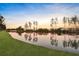 Scenic pond surrounded by trees and grass reflecting the sky at 108 Whaler Ave, Summerville, SC 29486