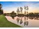 Scenic pond surrounded by trees and grass reflecting the sky at 108 Whaler Ave, Summerville, SC 29486