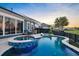 Backyard swimming pool and spa with beautiful blue tile and seating area at 108 Whaler Ave, Summerville, SC 29486