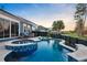 Backyard swimming pool and spa with beautiful blue tile and black fence at 108 Whaler Ave, Summerville, SC 29486