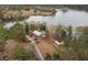 An aerial view showcases the property set amongst a lake and trees, offering a secluded and scenic retreat at 1107 Bellwether Ln, Summerville, SC 29485
