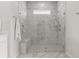 Modern bathroom with white marble floors, a spacious shower, and heated towel rack at 1107 Bellwether Ln, Summerville, SC 29485