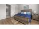 Bedroom with wood floors, a decorative headboard, and a bathroom view at 1107 Bellwether Ln, Summerville, SC 29485