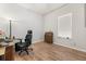 Bedroom features wood-look flooring, neutral walls, a window, and a desk area with a black gaming chair at 1107 Bellwether Ln, Summerville, SC 29485