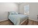 Cozy bedroom with a rustic wood-frame bed and ample natural light from the window at 1107 Bellwether Ln, Summerville, SC 29485